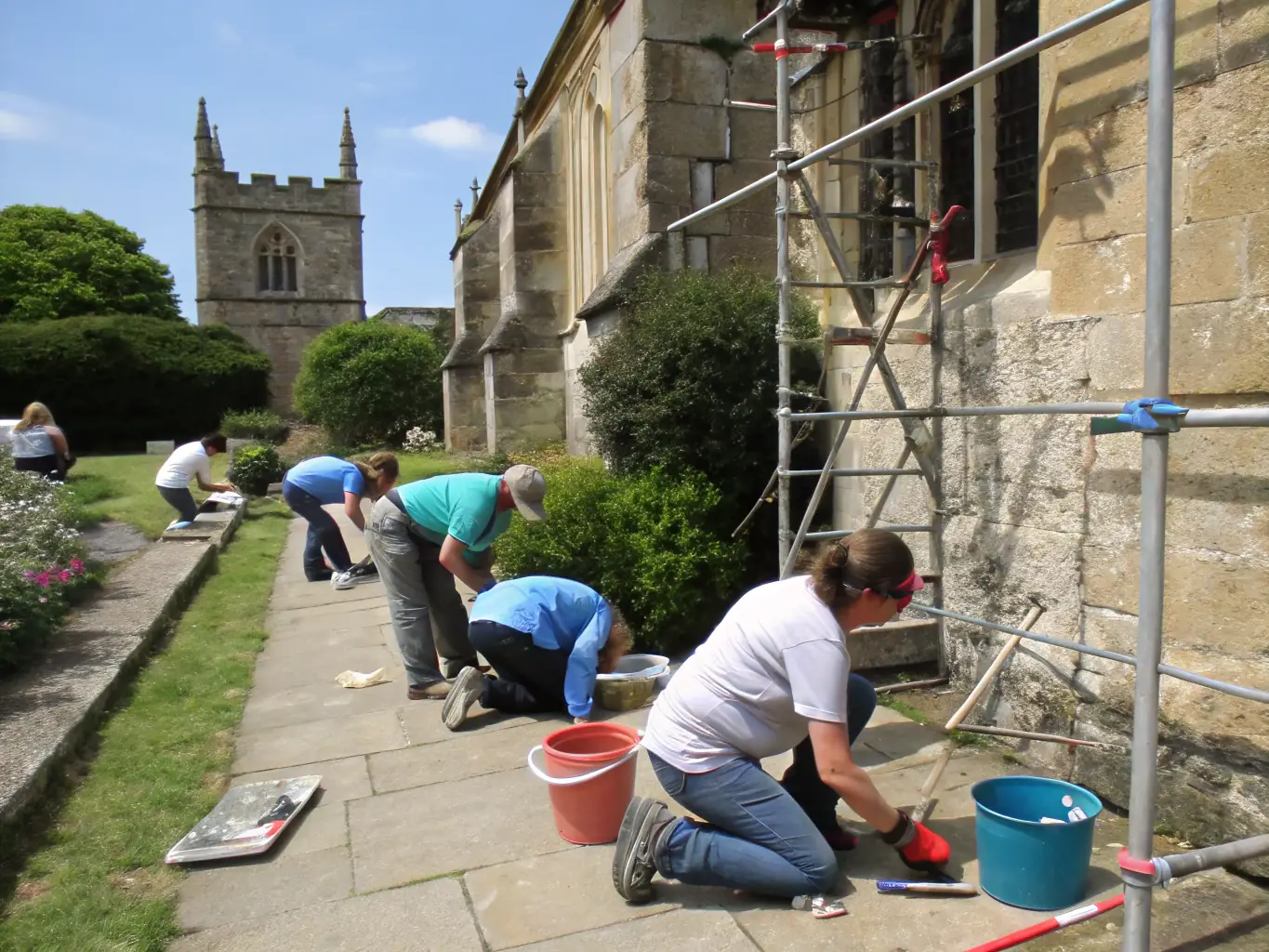Volunteers working together on a restoration project at the Château de Boulbon, carefully repairing stonework and preserving the castle's structure.